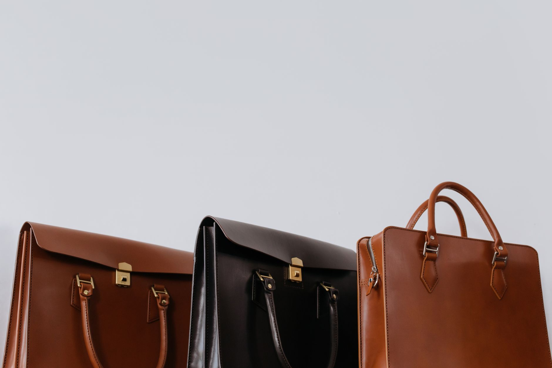 Woman carrying a structured leather tote bag in an urban setting