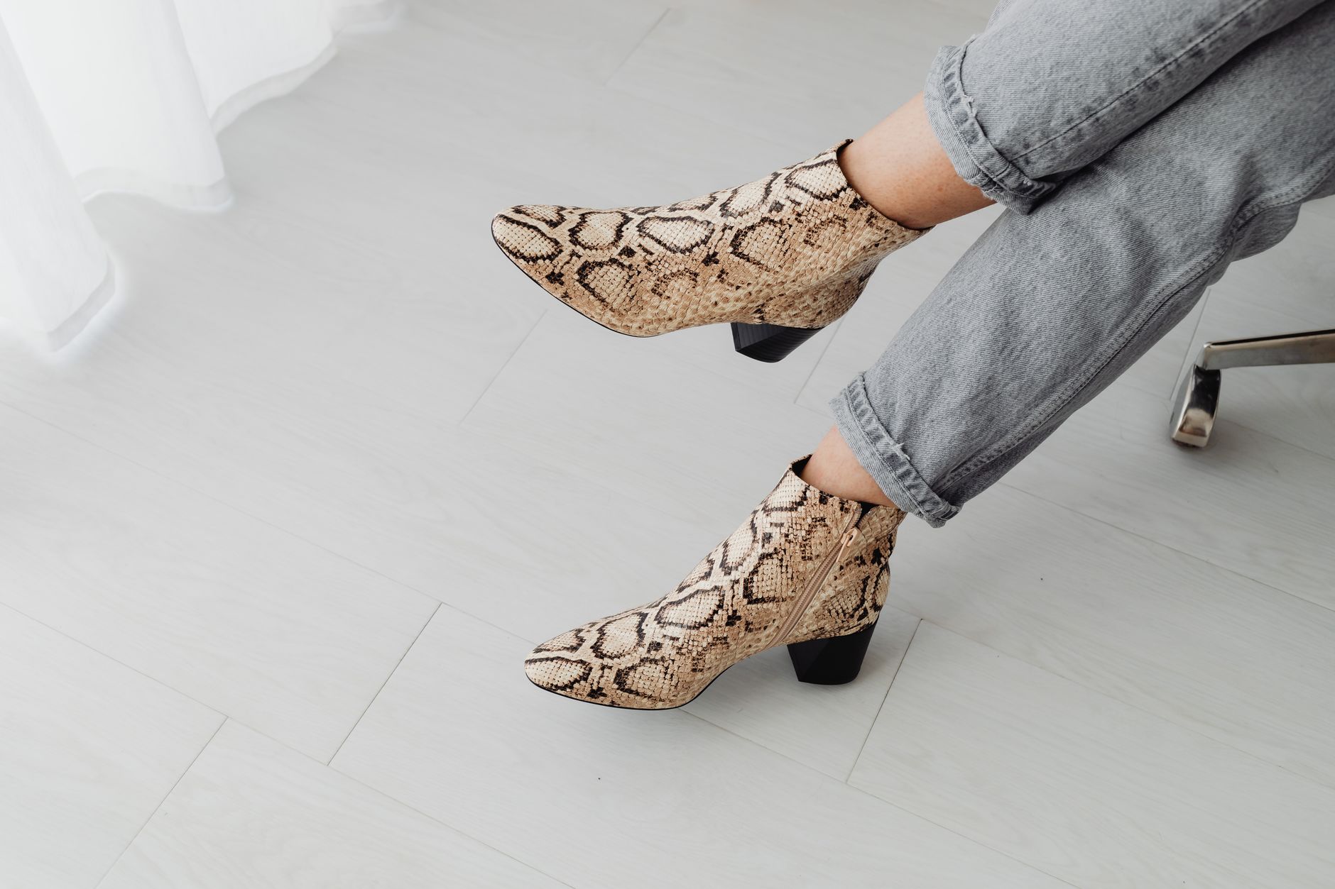 Woman wearing tall knitted boots styled with wide-leg trousers in a minimal fashion setting
