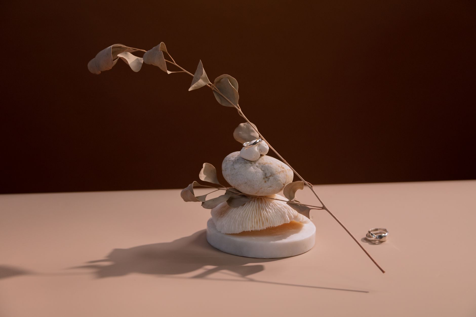 Minimal fine jewelry pieces including thin gold bands displayed on a clean background