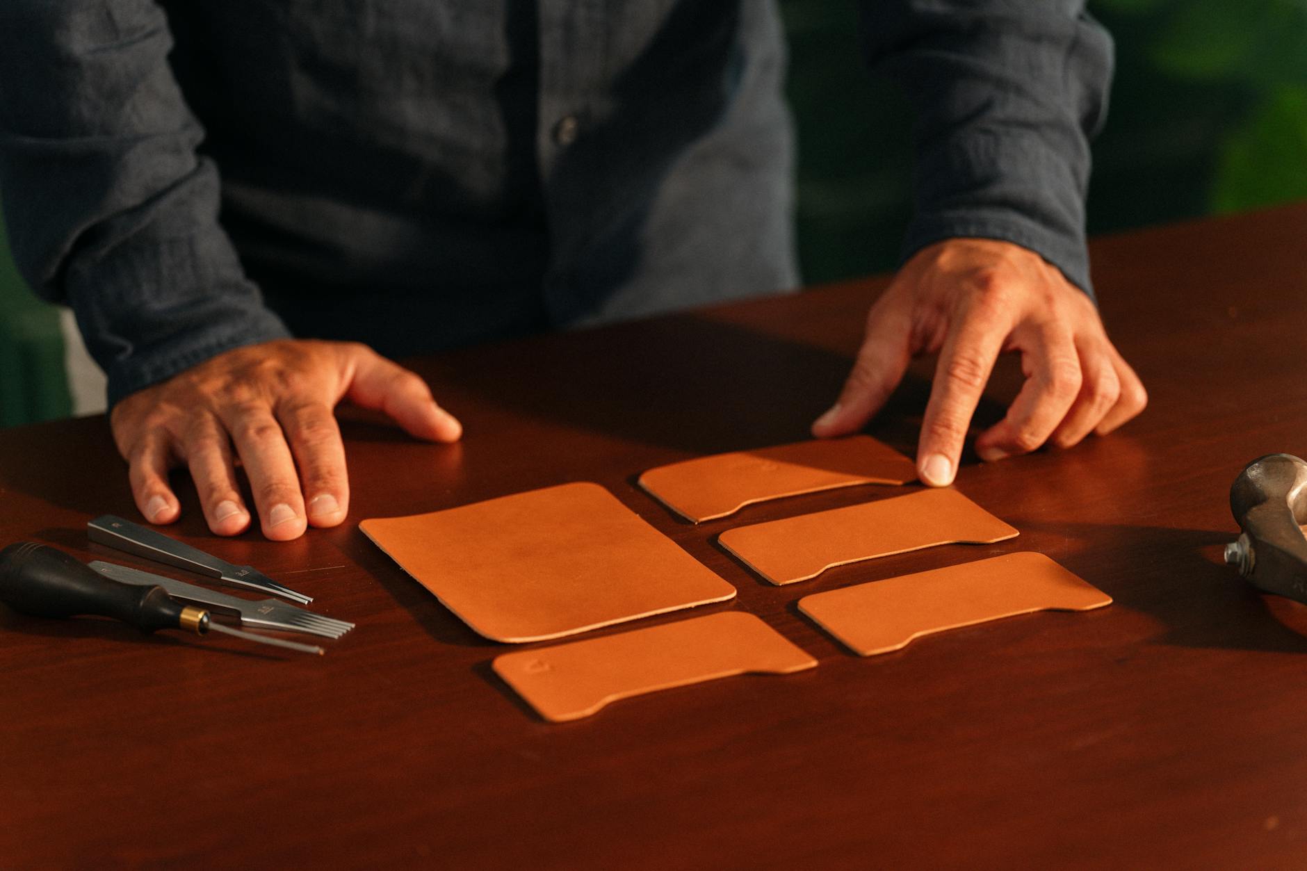 Artisan hands working on precision leather stitching for a luxury handbag