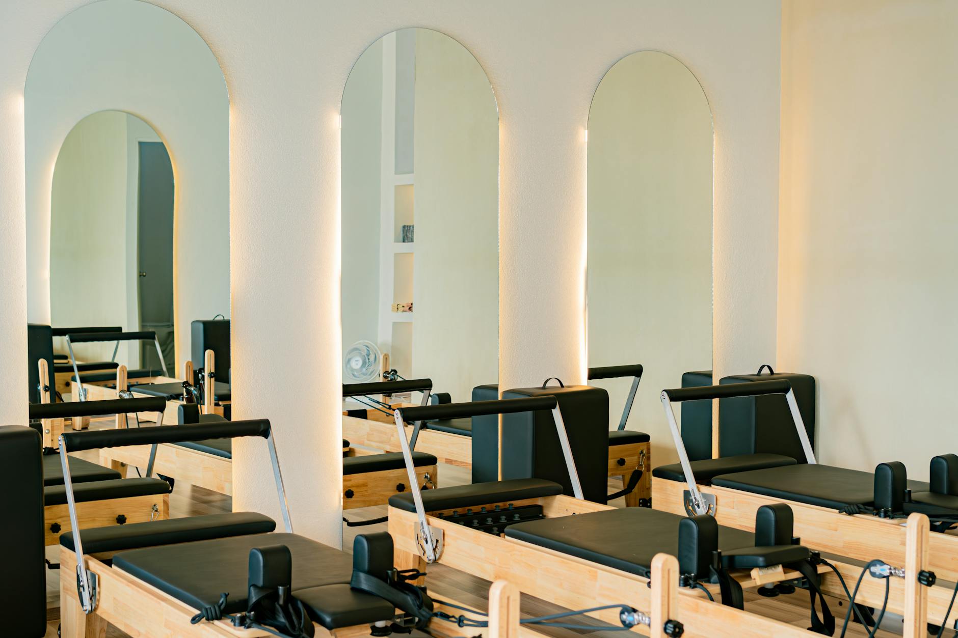Clean modern fitness studio interior with minimal equipment and natural lighting