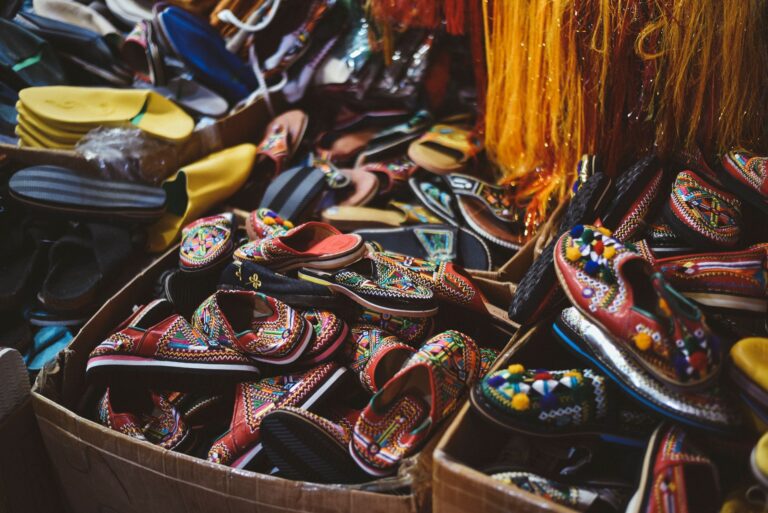 Close-up of woven leather mule shoes on a neutral background