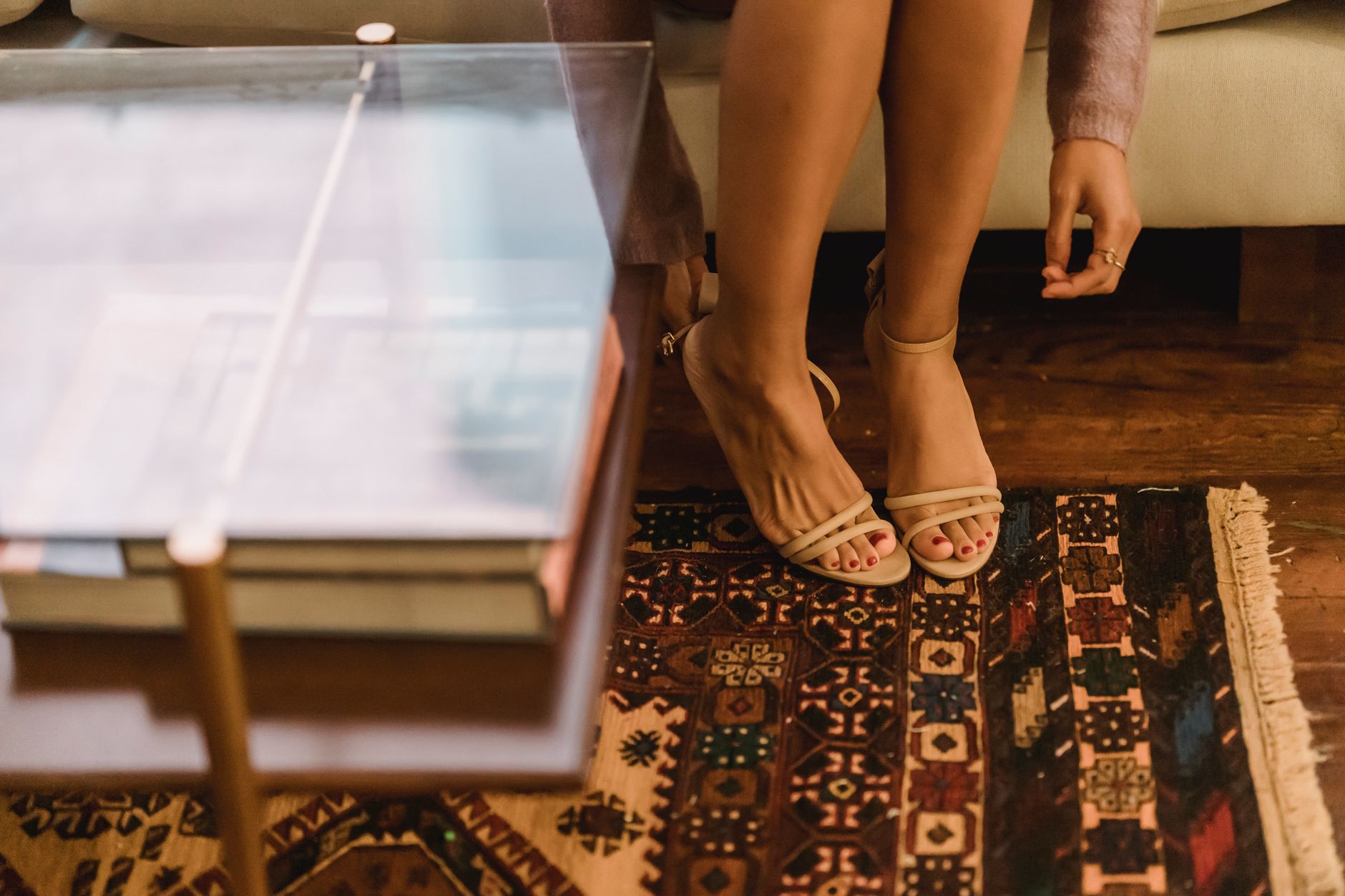 Close-up of a pair of minimalist leather flat sandals on a clean surface