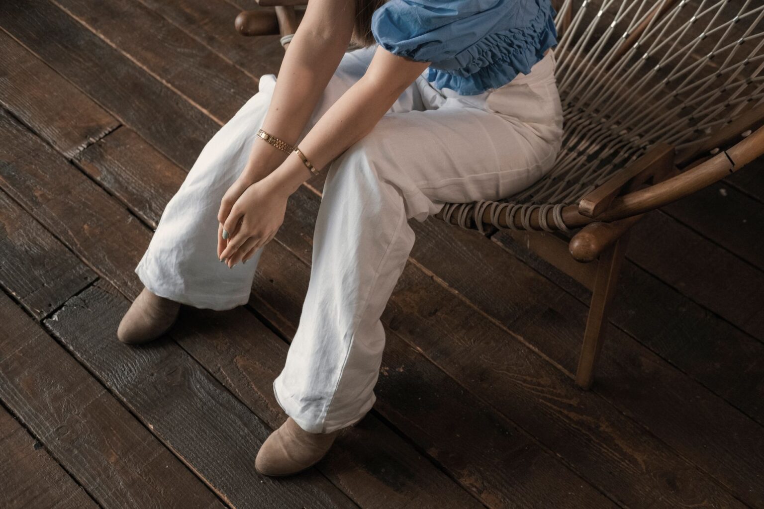 Toteme’s Fluid Trousers Are Quietly Edging Out the Wide Leg Woman wearing flowing, high-waisted fluid trousers in neutral tones