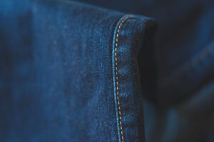 The Quiet Return of Helmut Lang’s Raw Hem Denim Close-up of raw hem denim jeans showing unfinished frayed edge at ankle