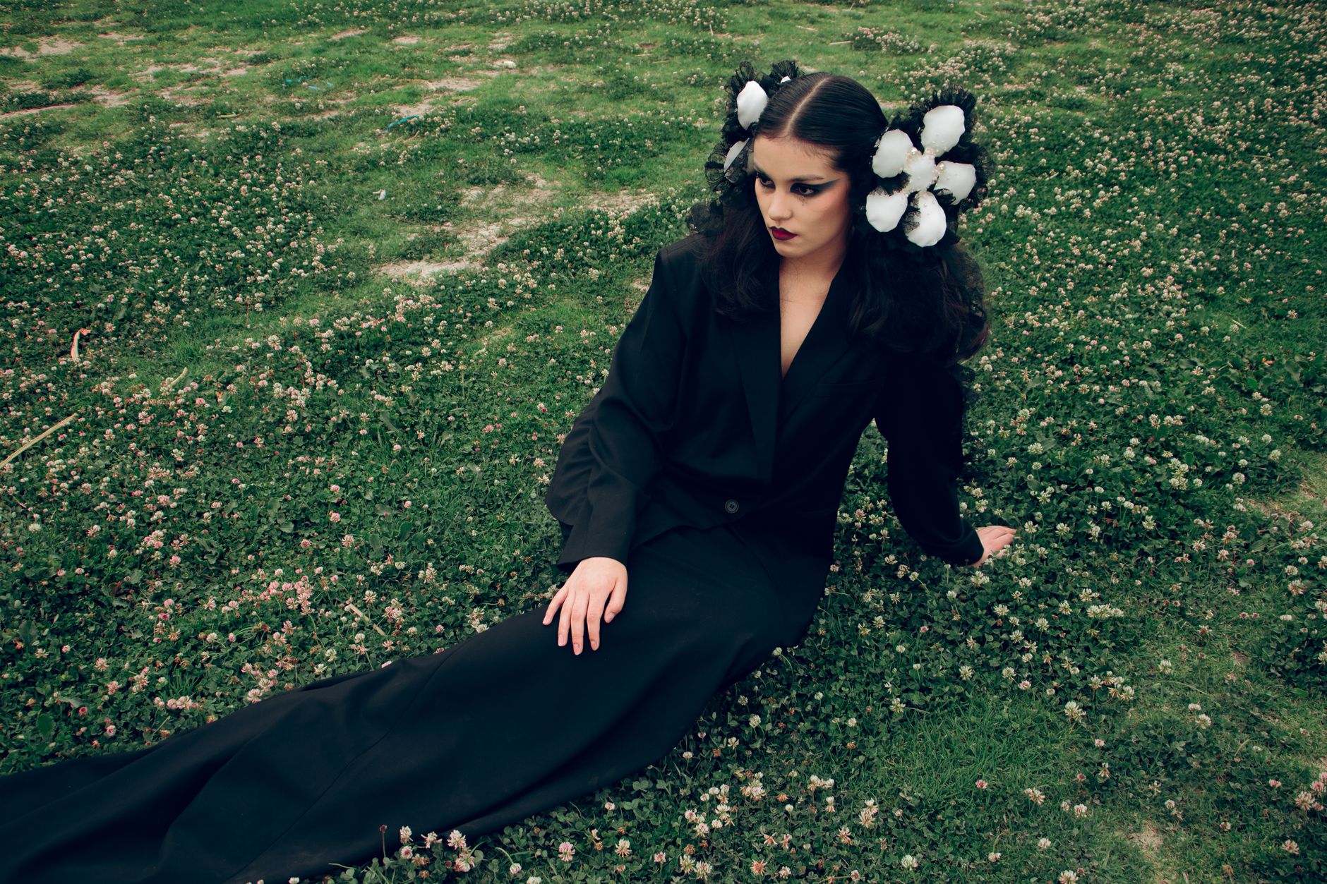 A dark, moody fashion editorial image representing avant-garde clothing aesthetics