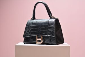 Celine’s Triomphe Canvas Is Quietly Outlasting the Logo Bag Moment Close-up of a structured canvas luxury handbag with subtle geometric pattern