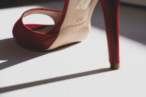 Versace’s Medusa Heel Is Quietly Outlasting the Platform Moment Close-up of a pair of elegant stiletto heels with gold hardware detail against a neutral background