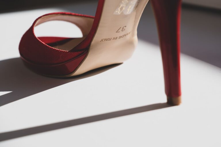 Versace’s Medusa Heel Is Quietly Outlasting the Platform Moment Close-up of a pair of elegant stiletto heels with gold hardware detail against a neutral background