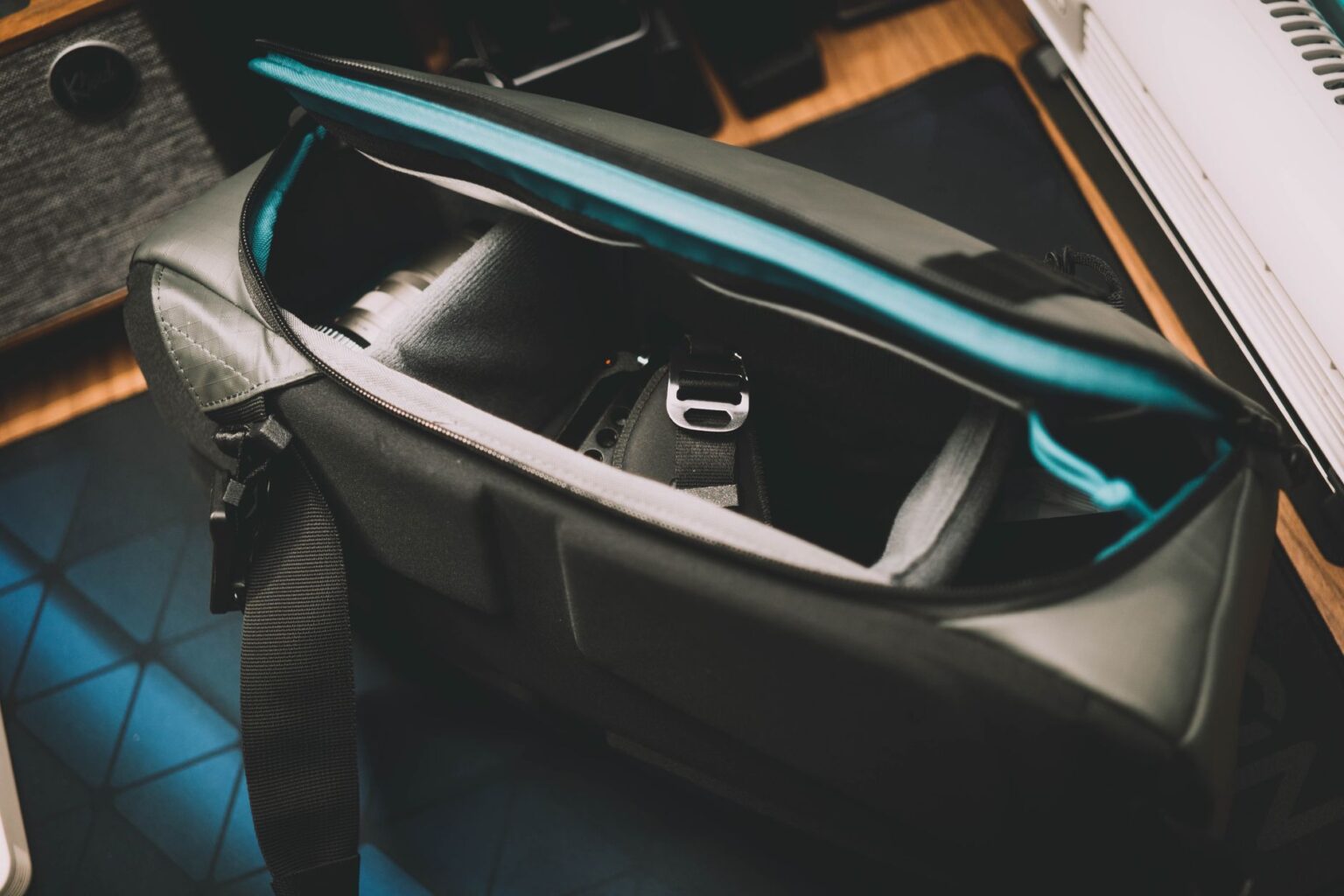Prada’s Re-Nylon Bag Is Quietly Outlasting the Logo Tote Close-up of a structured nylon shoulder bag with minimal hardware on a neutral background