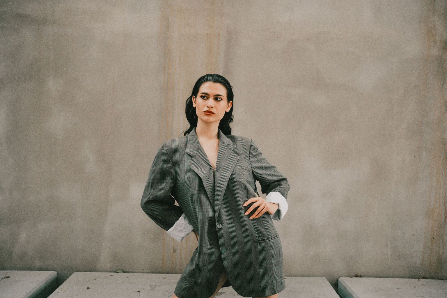 Saint Laurent’s Tuxedo Blazer Is Quietly Outlasting the Leather Jacket A woman wearing a sharp black tuxedo blazer with satin lapels