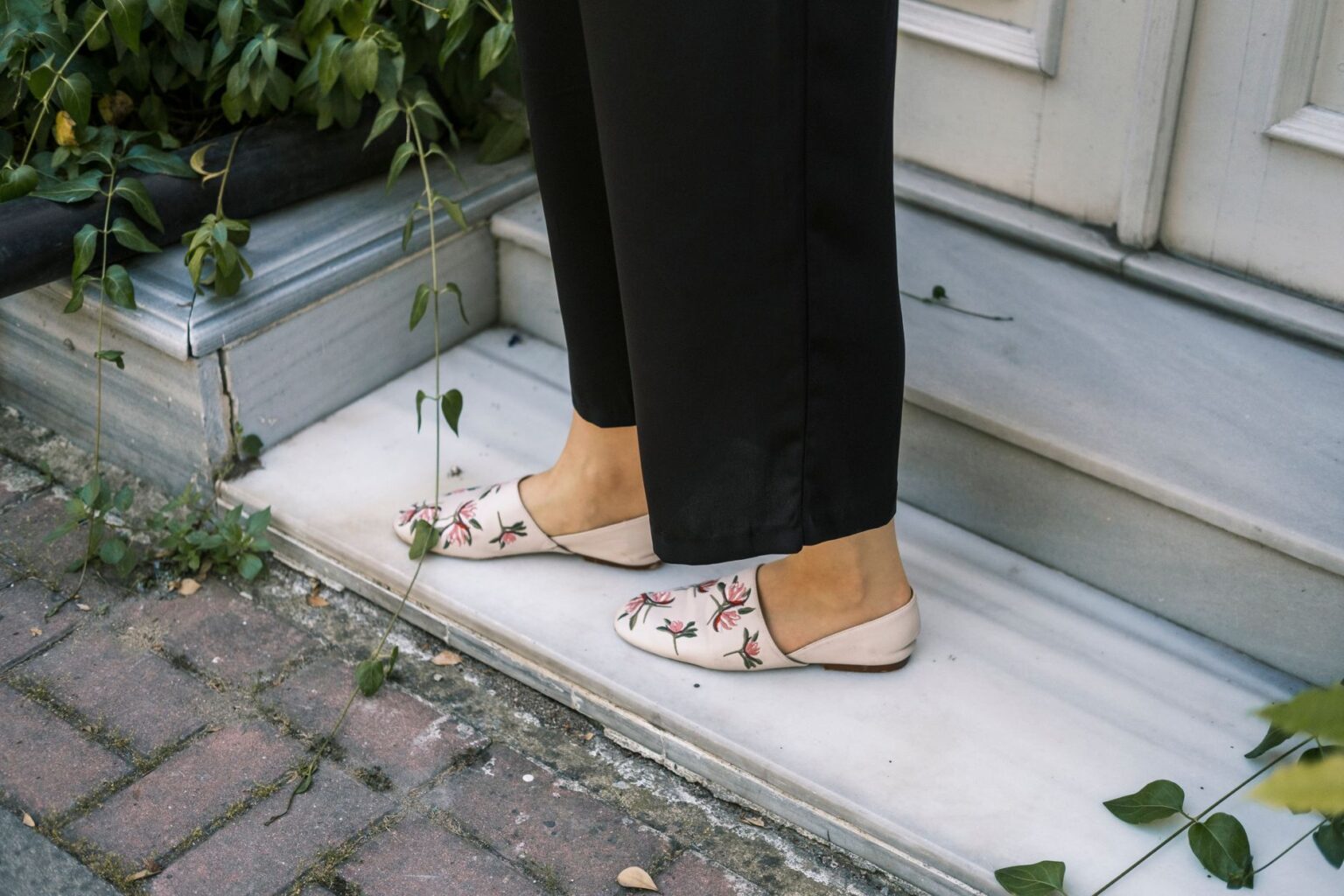 Close-up of elegant women's flat shoes with buckle detail on a clean surface