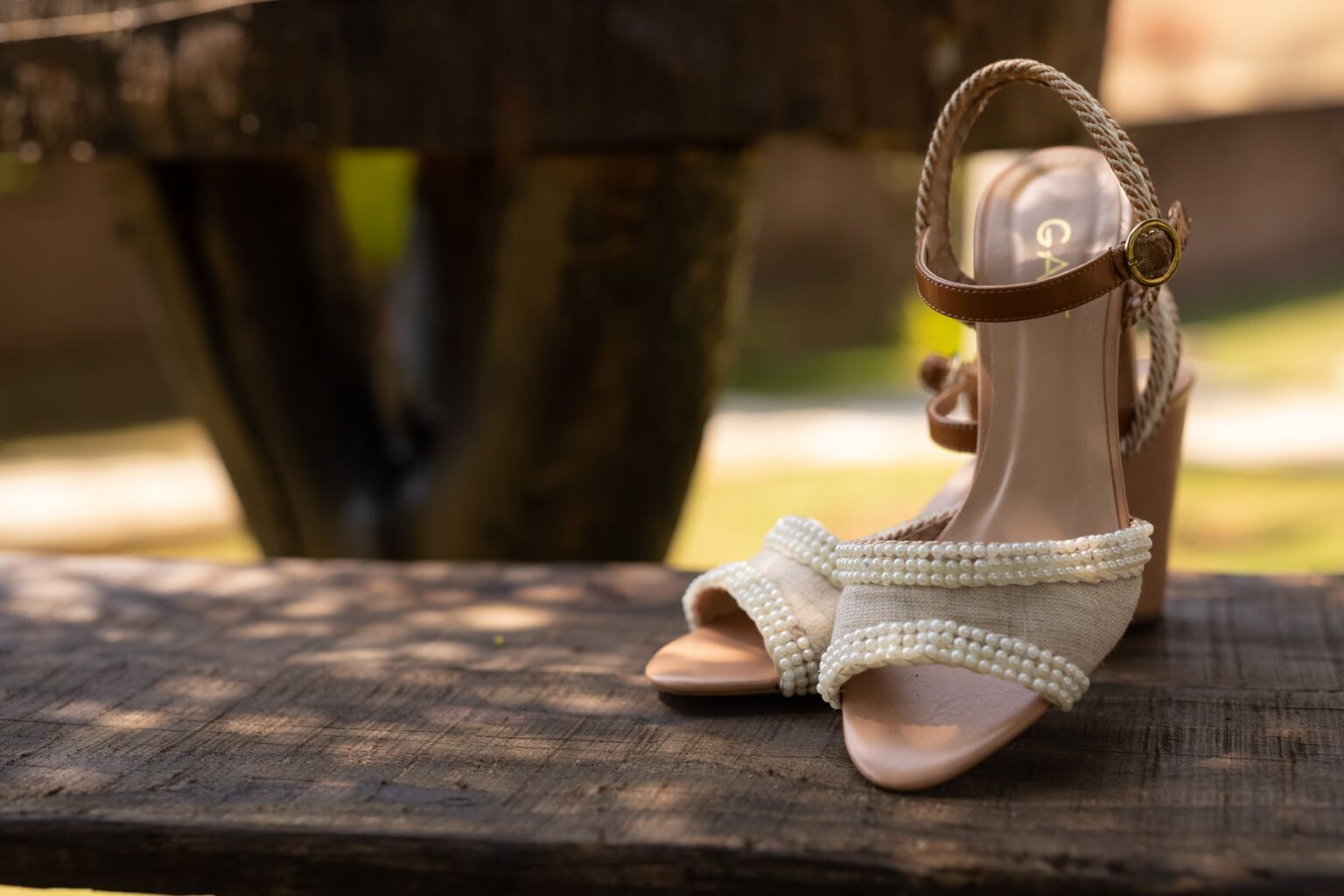 Close-up of wooden block-heel sandals on a neutral background