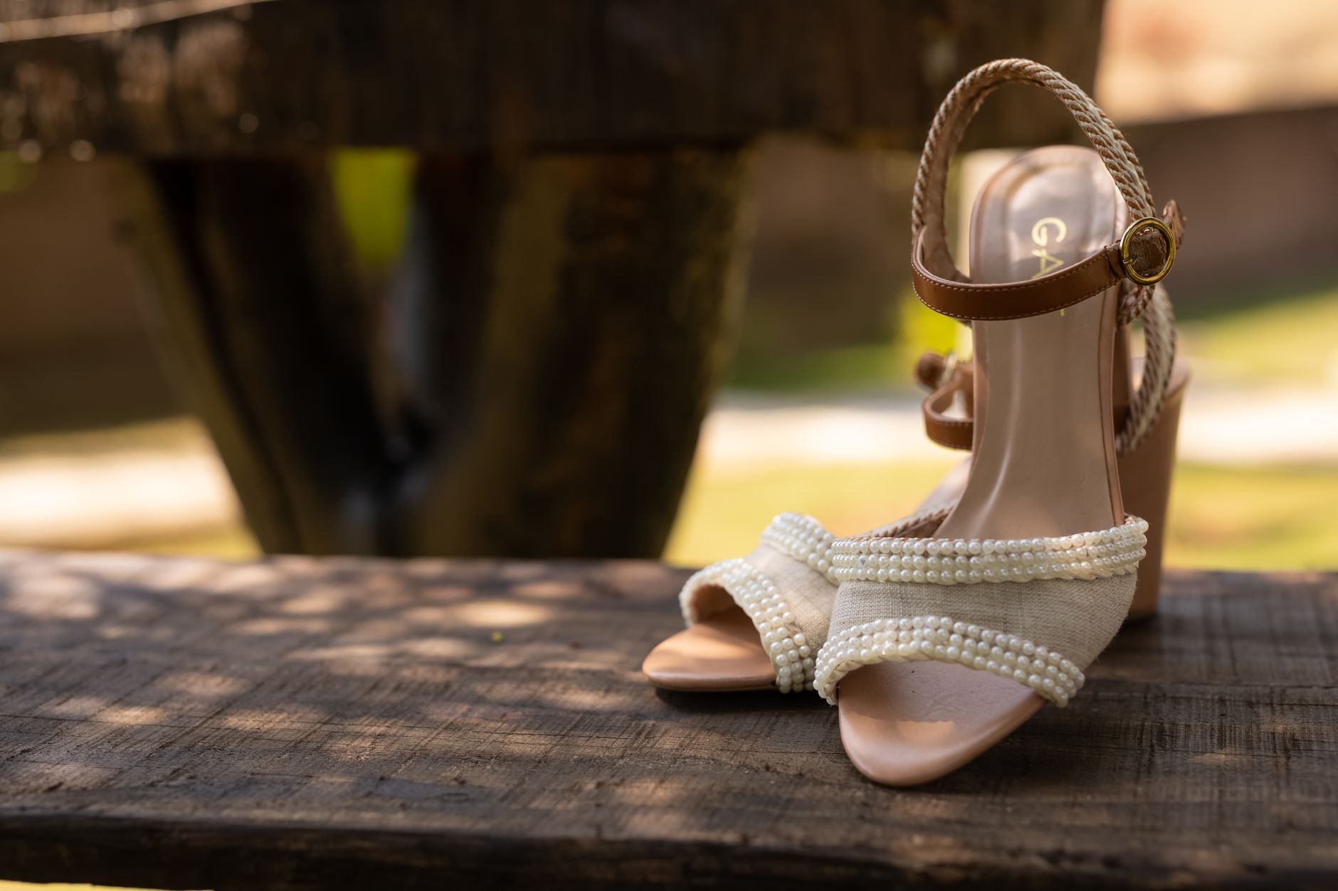 Close-up of wooden block-heel sandals on a neutral background