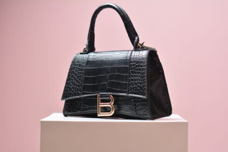 Celine’s Triomphe Canvas Is Quietly Outlasting the Logo Bag Moment Close-up of a structured canvas luxury handbag with subtle geometric pattern