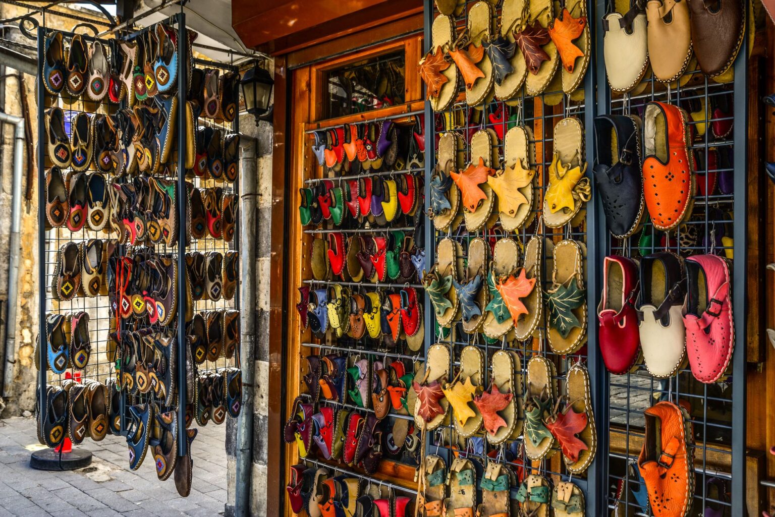 A retail display of casual slip-on shoes including mule and clog styles