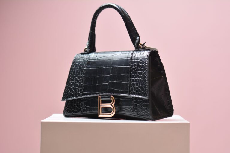 Close-up of a structured canvas luxury handbag with subtle geometric pattern