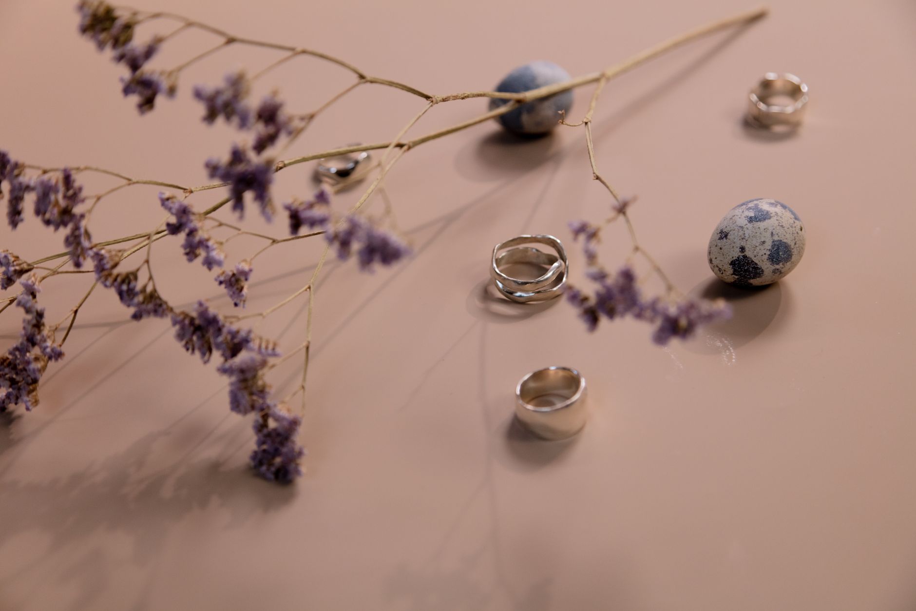 Minimalist metal earrings and accessories arranged on a clean surface