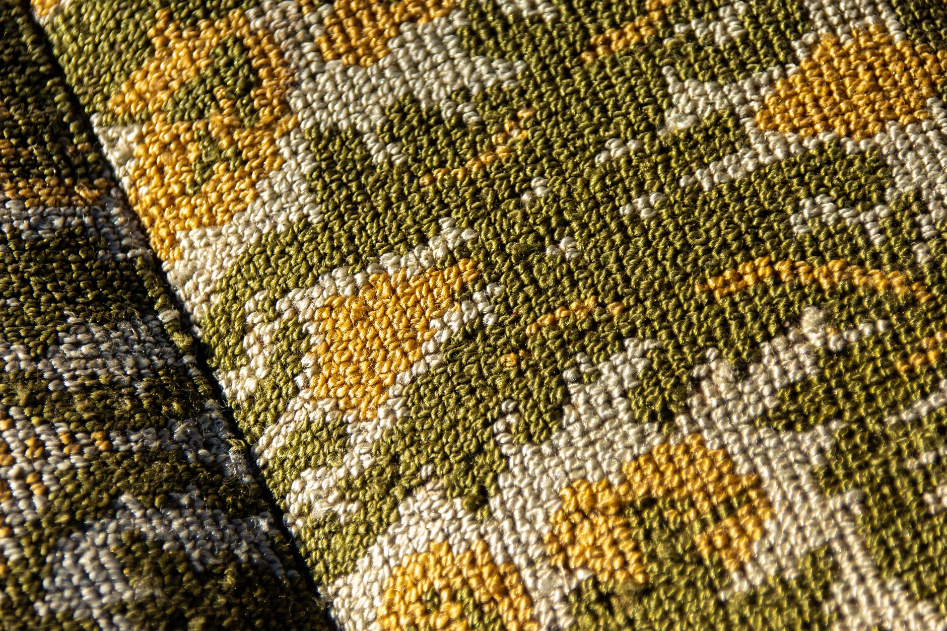 Close-up detail of embroidered and printed fabric from a high-end designer garment