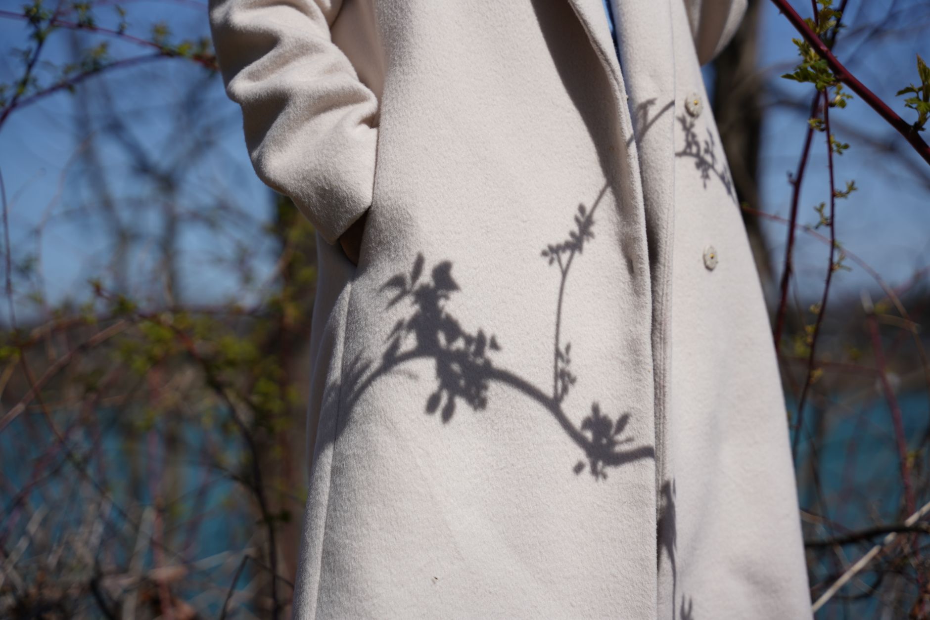 Close-up of a structured minimalist coat with clean lines and neutral tones