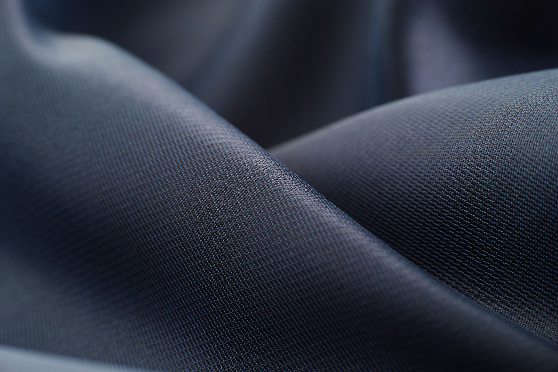 Close-up of a high-quality satin or crepe fabric catching light