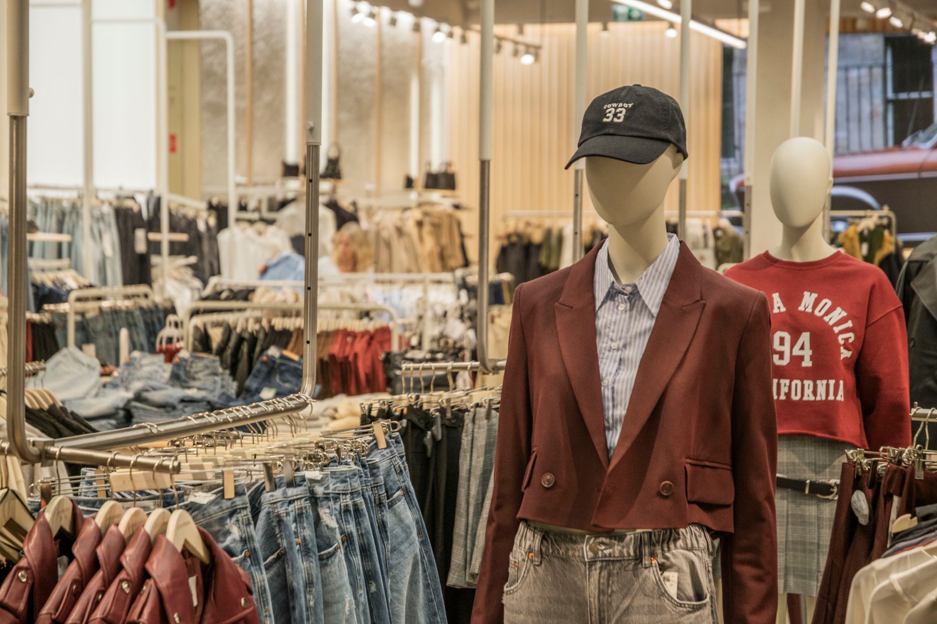 Minimalist luxury fashion boutique interior with bags displayed on shelves