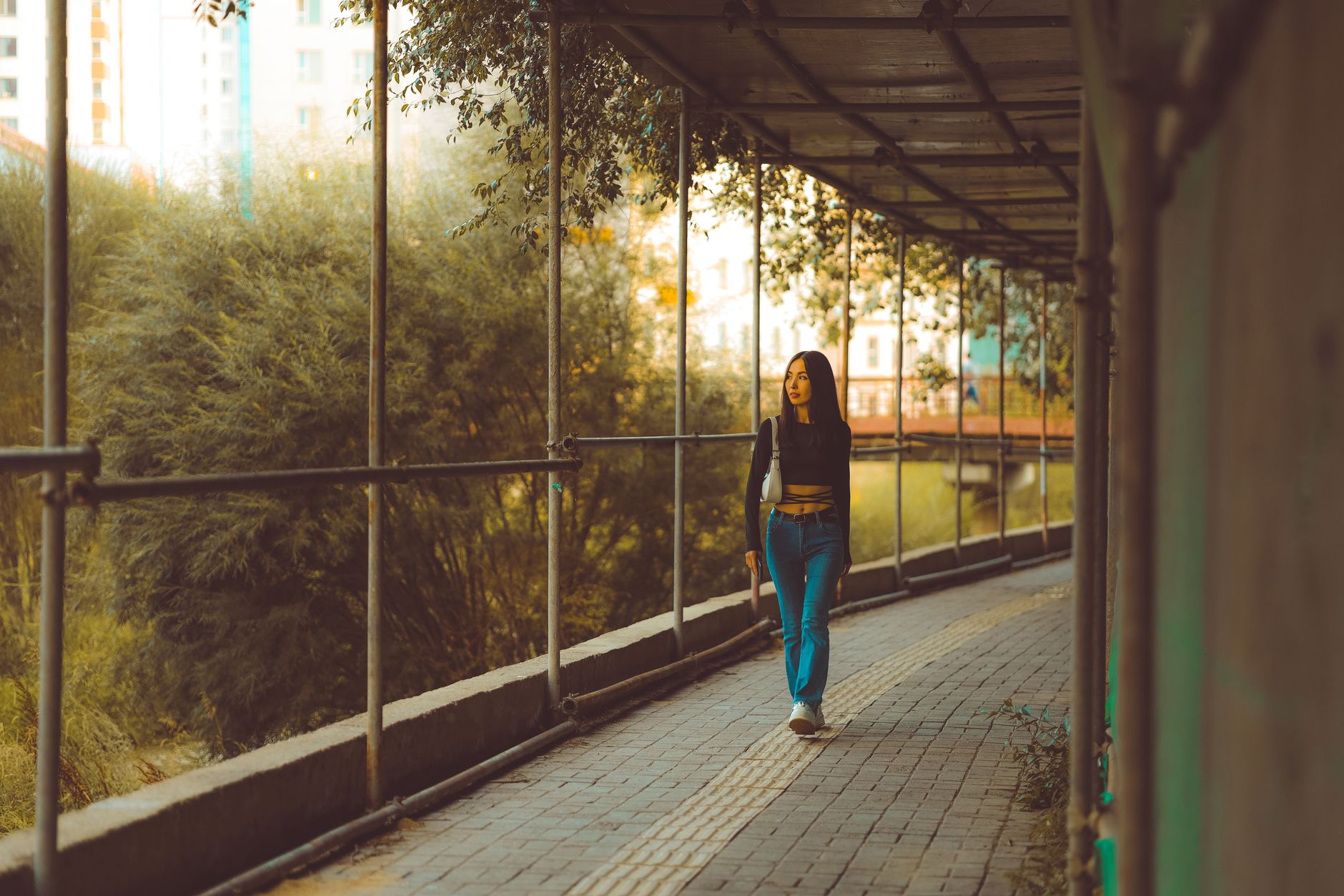 Woman walking in a city street wearing a distinctive boot silhouette