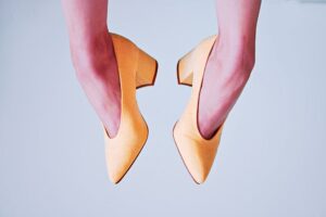 Bottega Veneta’s Stretch Heels Are Edging Out the Mule Woman wearing sleek heels styled with tailored trousers