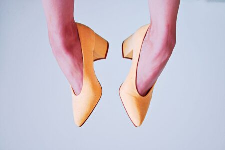 Bottega Veneta’s Stretch Heels Are Edging Out the Mule Woman wearing sleek heels styled with tailored trousers