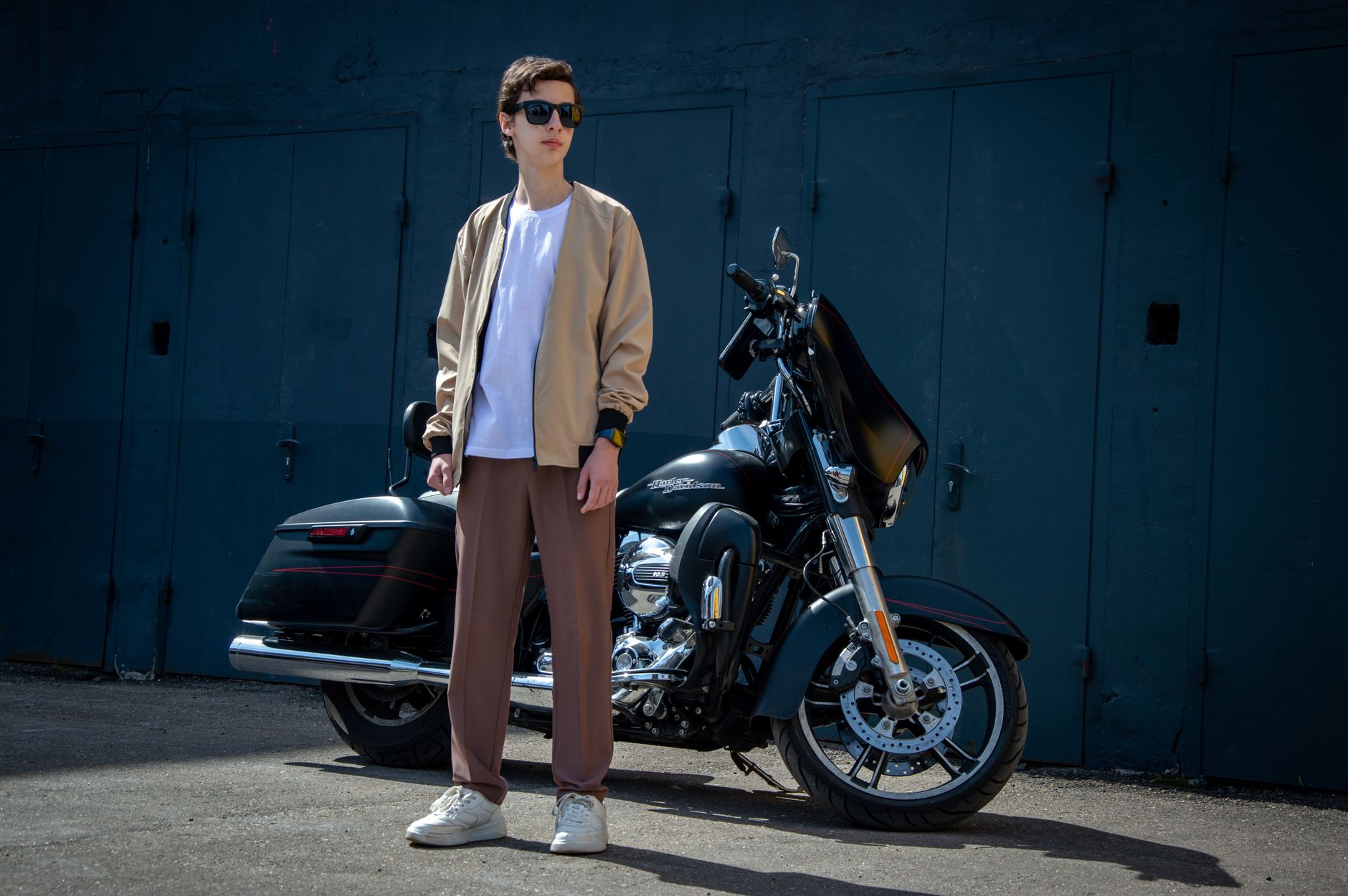 A clean, minimal bomber jacket laid flat against a neutral background