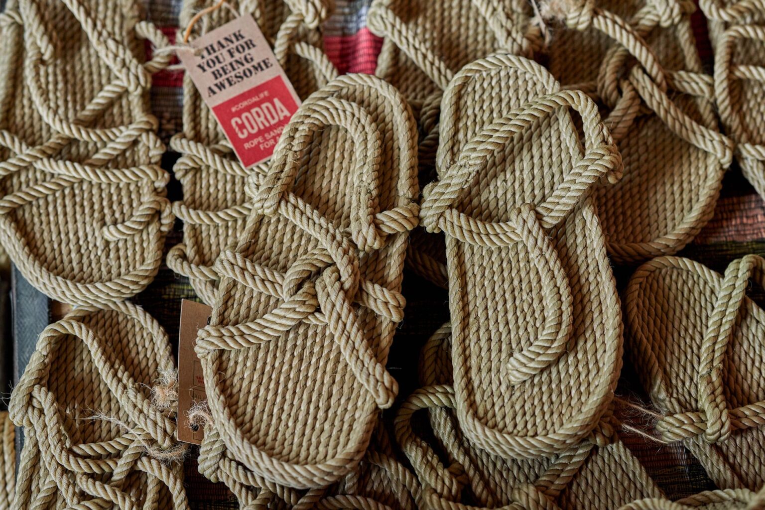 Close-up of brown leather fisherman sandals on a wooden surface