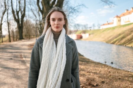 Toteme’s Merino Tube Scarf Is Quietly Unseating the Wool Beanie A neatly folded merino tube scarf in a neutral tone laid flat on a light surface