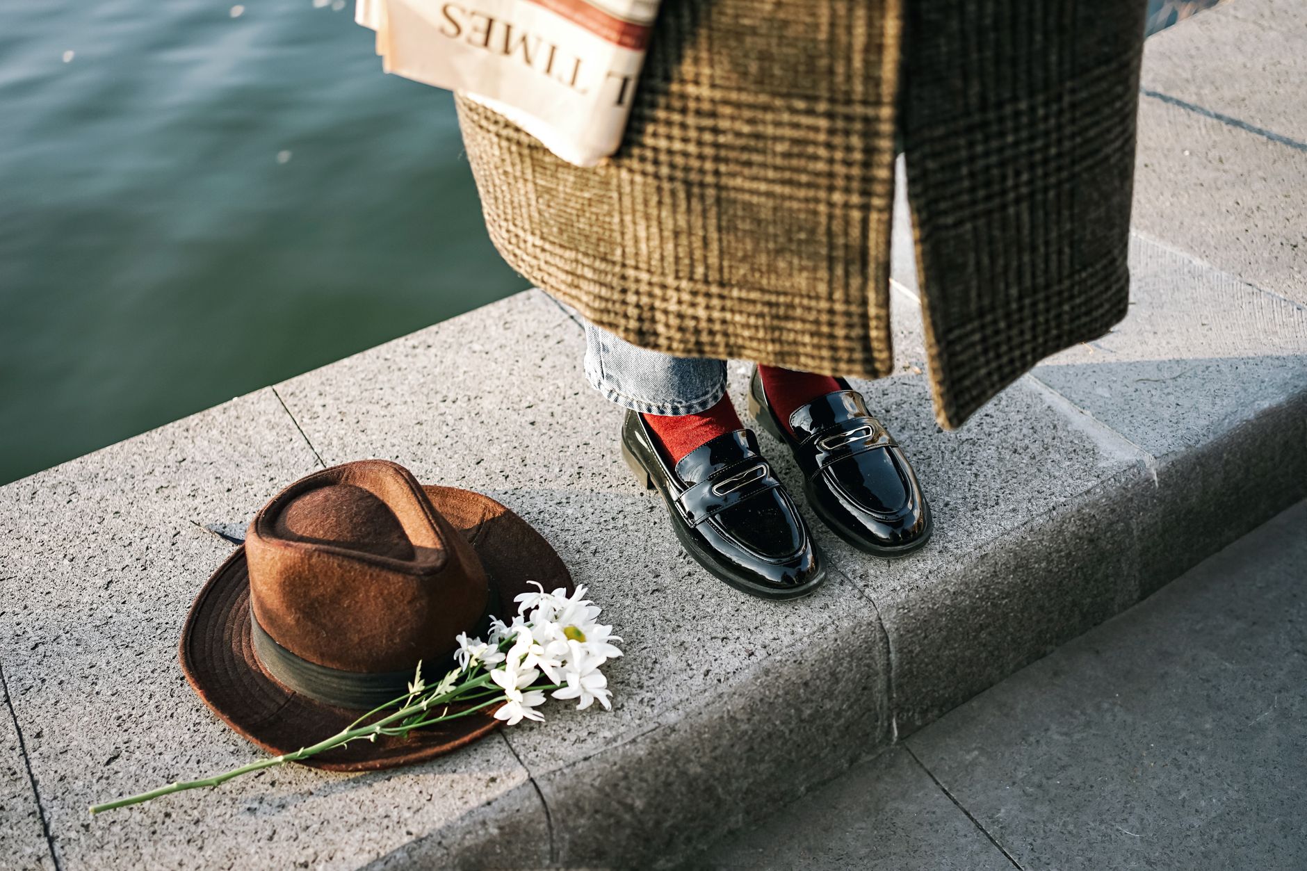 Pair of padded loafers styled with wide-leg trousers on a polished surface