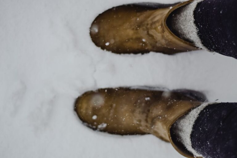 Acne Studios’ Shearling Boot Is Quietly Edging Out the Chelsea Close-up of shearling-trimmed ankle boots on a wooden floor