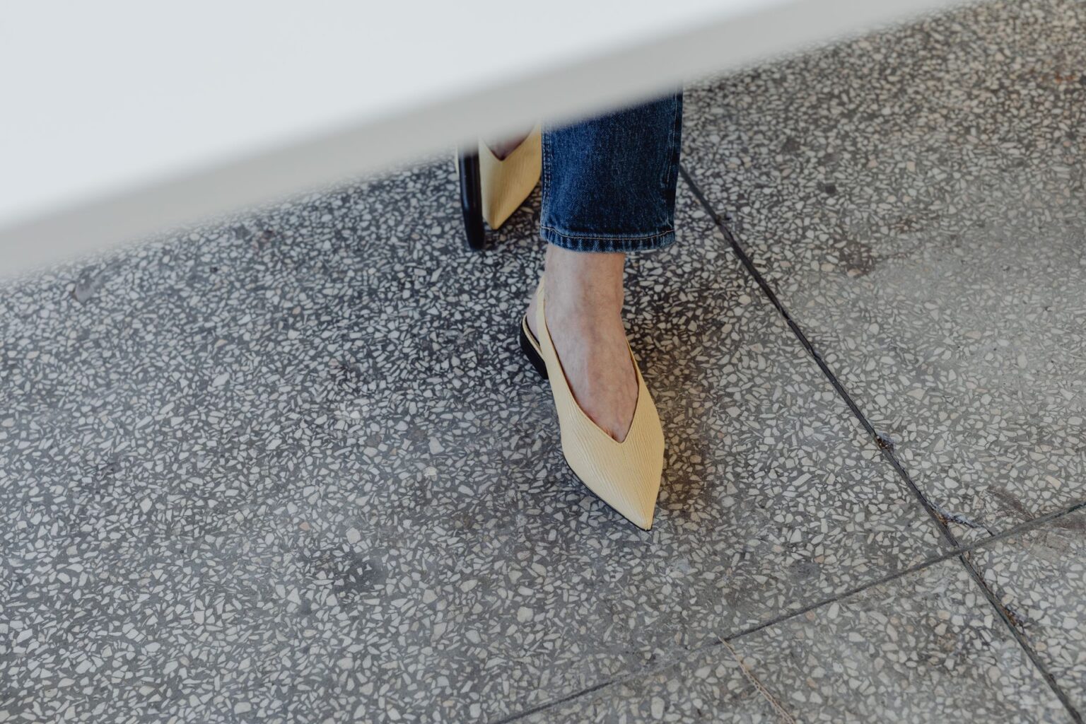 The Pointed-Toe Flat Is Quietly Edging Out the Round-Toe Shoe A pair of sleek pointed-toe flat shoes in neutral leather on a clean surface