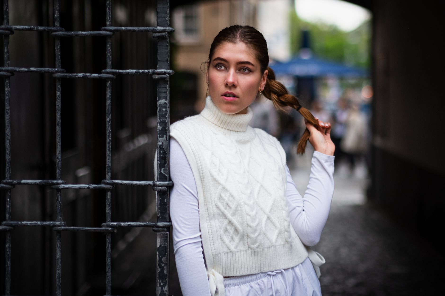 A ribbed knit vest styled over a white collared shirt, worn as a layering piece