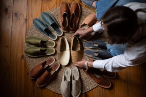 The Grosgrain Ribbon Flat Is Quietly Edging Out the Mary Jane Neutral-toned flat shoes with ribbon detail arranged on a clean surface
