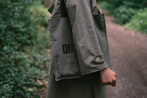 The Celine Triomphe Canvas Is Quietly Edging Out the Monogram Tote Close-up of a structured canvas tote bag with subtle logo pattern on a neutral background