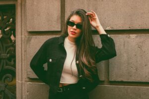 The Tweed Jacket Is Quietly Edging Out the Leather Blazer Woman wearing a tailored tweed jacket styled with modern casual clothing