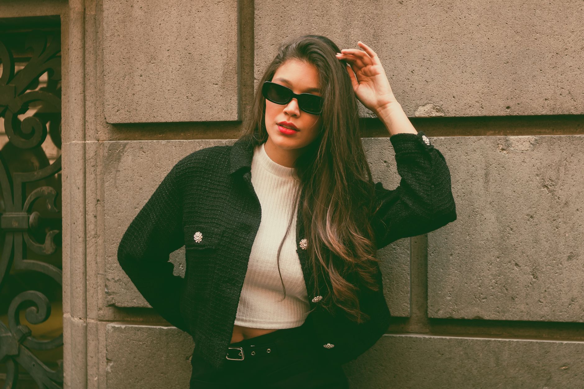 Woman wearing a tailored tweed jacket styled with modern casual clothing