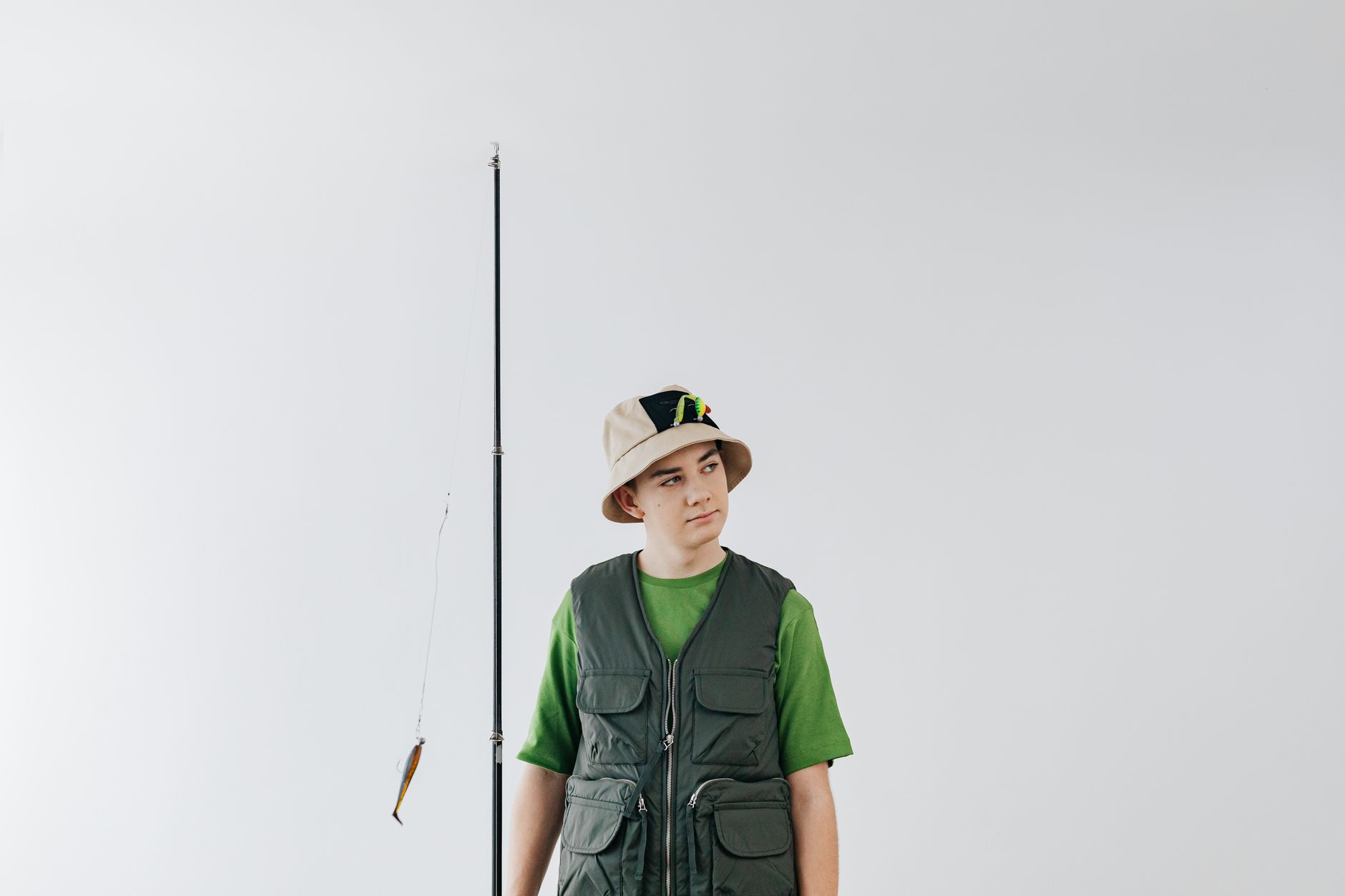 Person wearing a neutral-toned fisherman cap on a city street