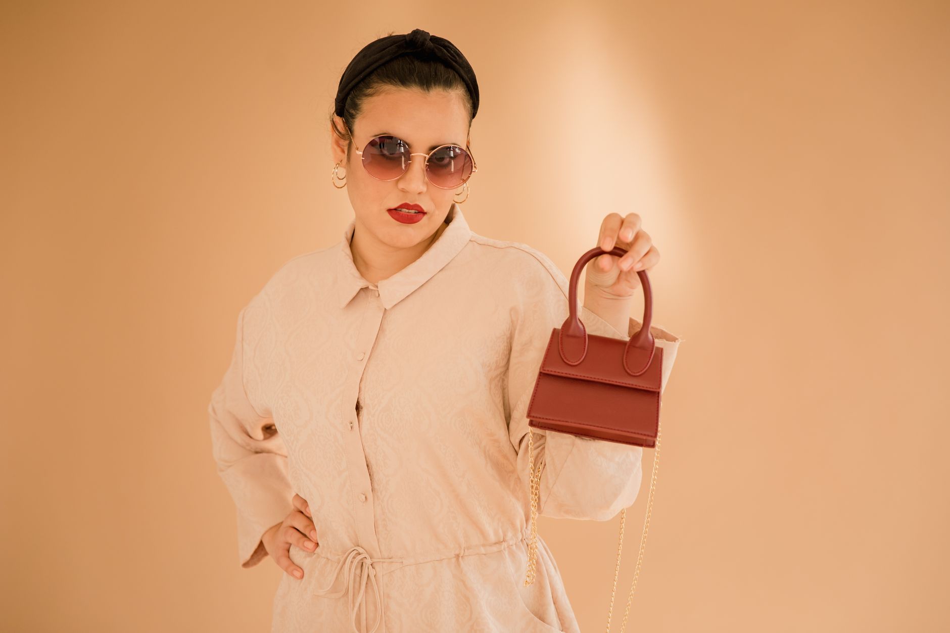 An editorial-style arrangement of designer handbags in muted tones