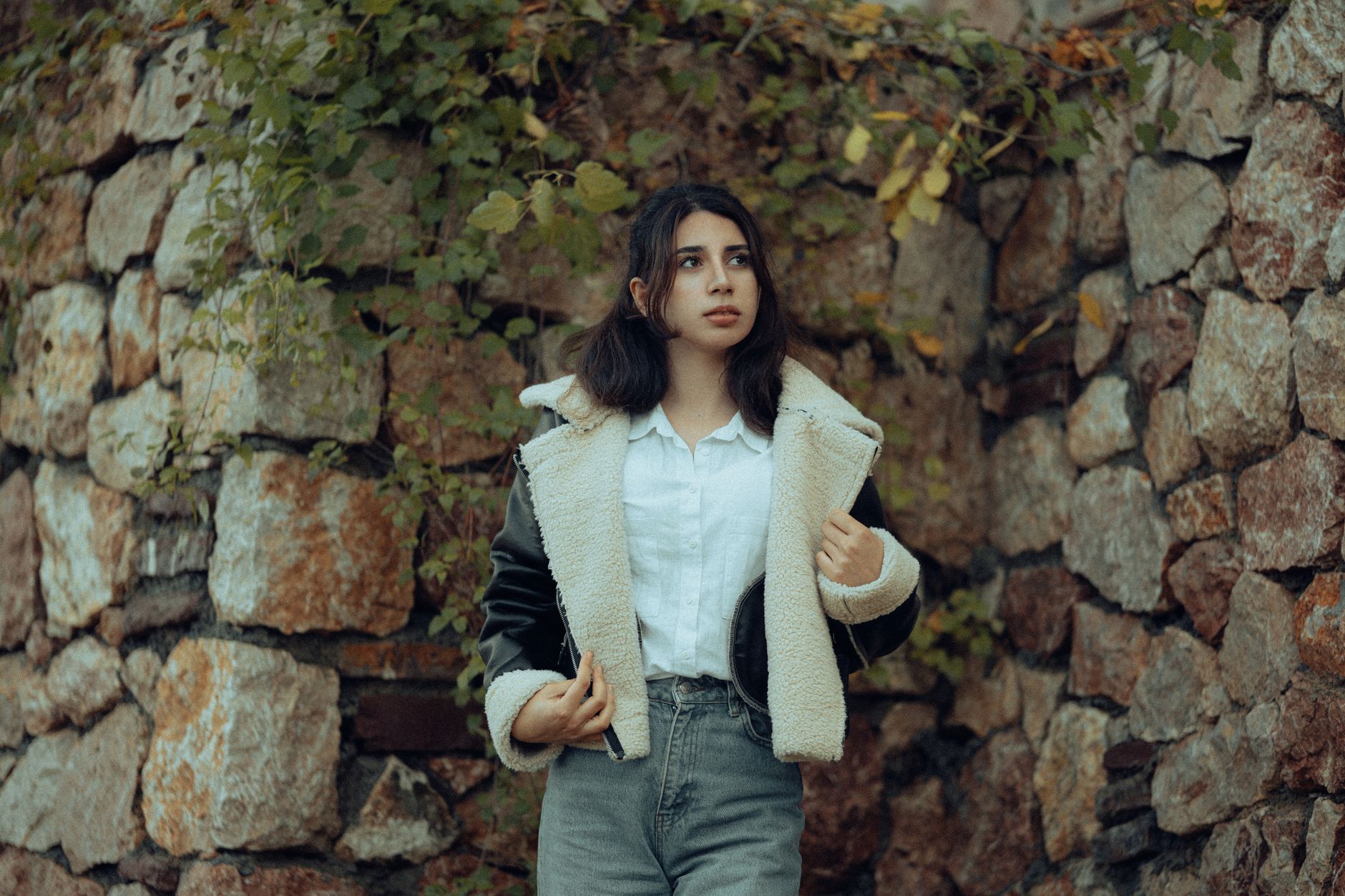 Woman styled in a plush teddy jacket against a neutral background