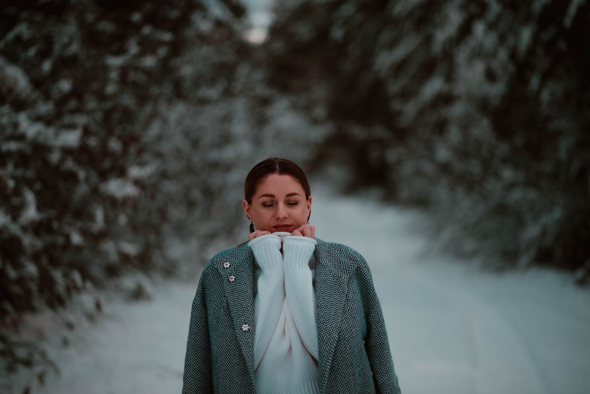 Person wearing textured winter outfit with boots on a city street