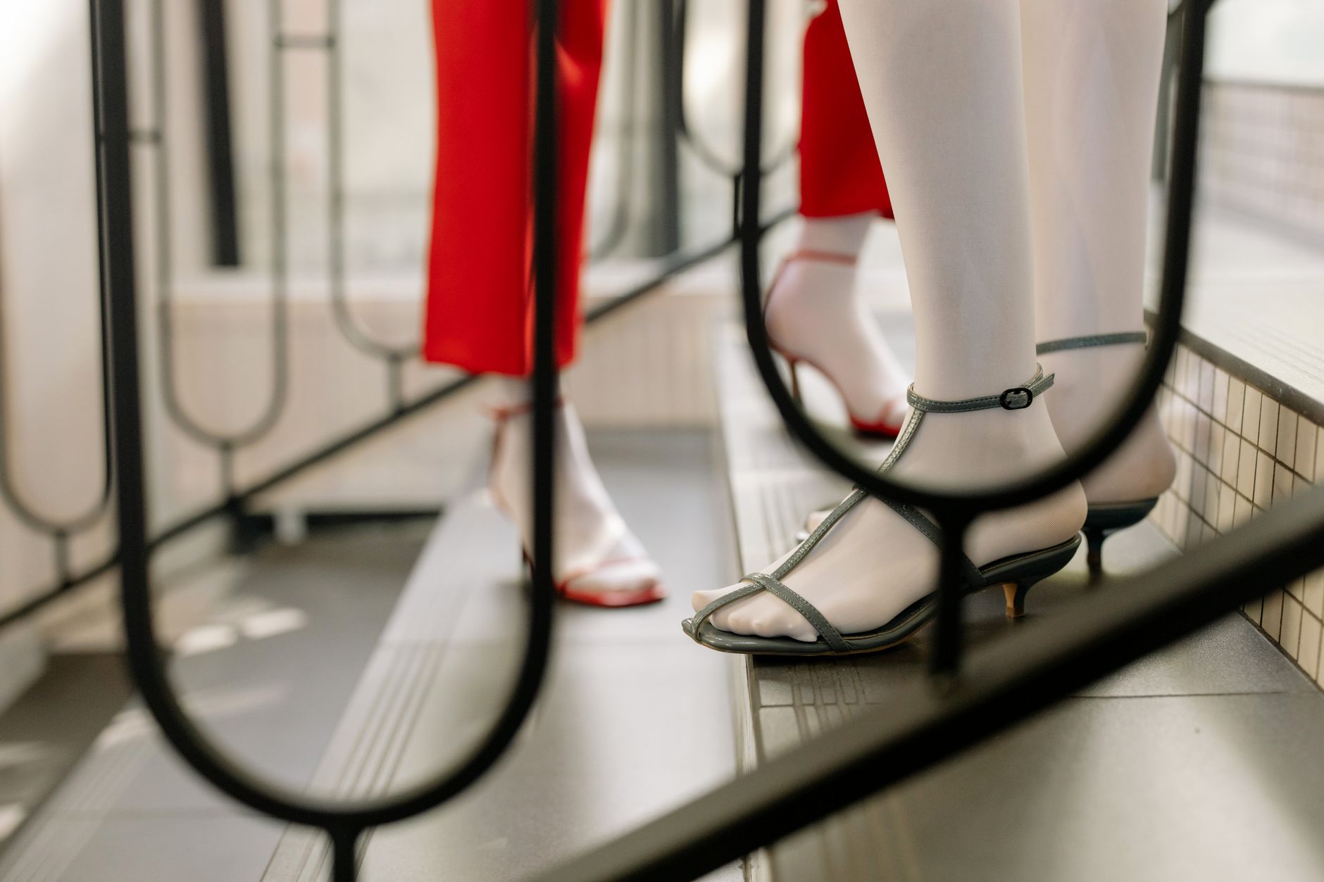 Close-up of strappy leather sandals with thin ankle ties on a light background