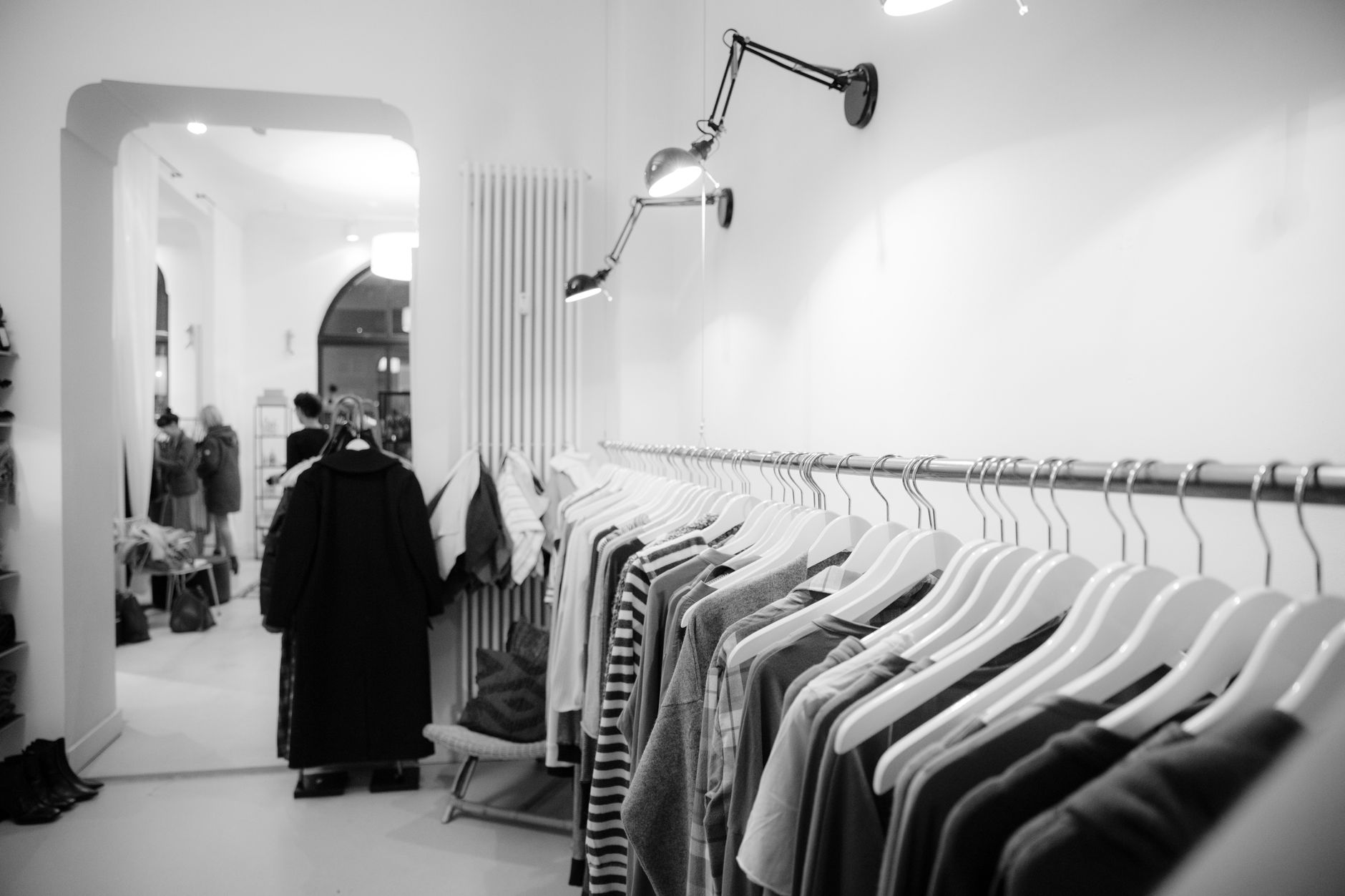 Interior of a high-end fashion boutique with bags displayed on minimalist shelving