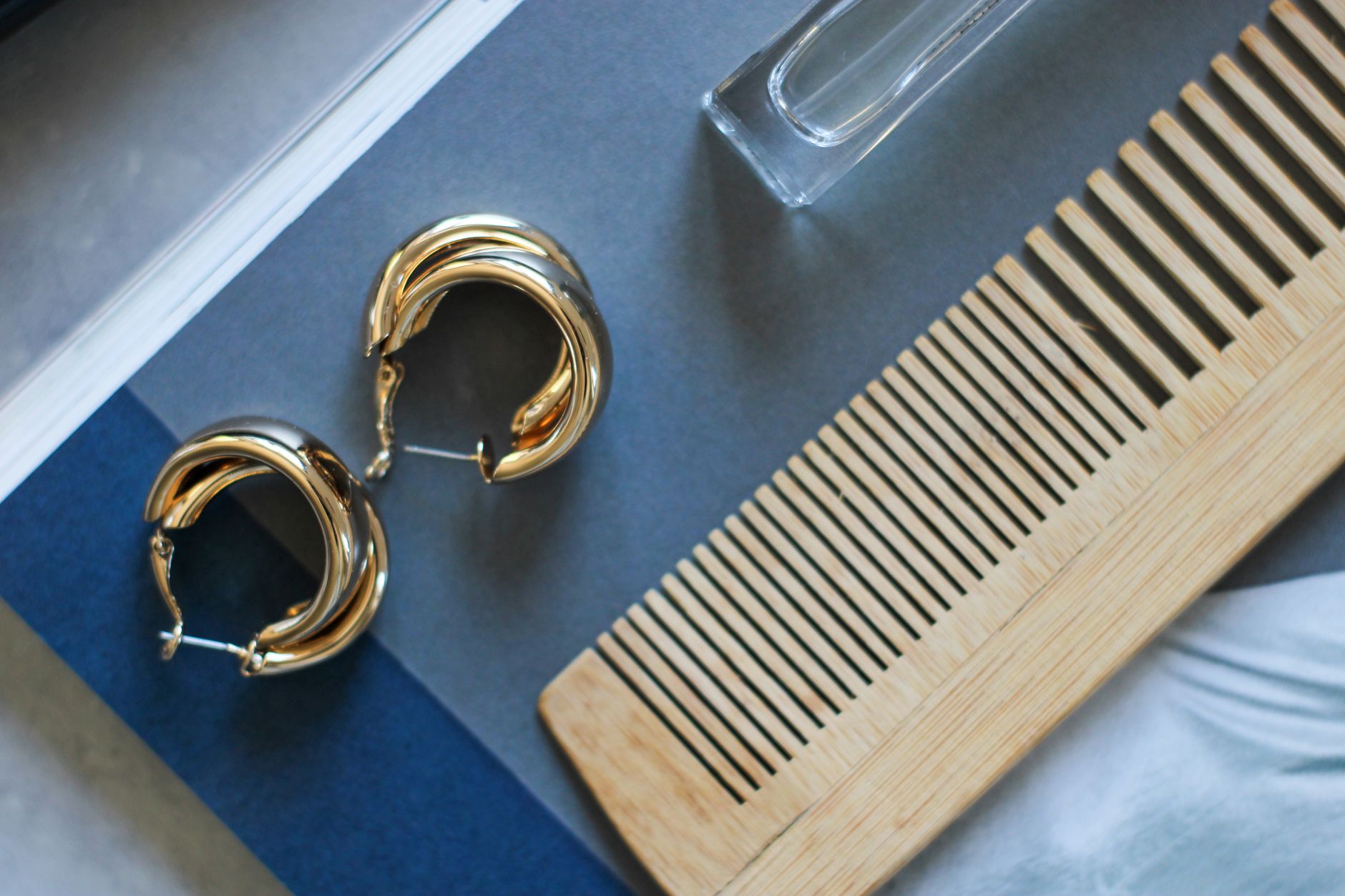 Close-up of minimalist accessories including a thin scarf styled on a neutral outfit