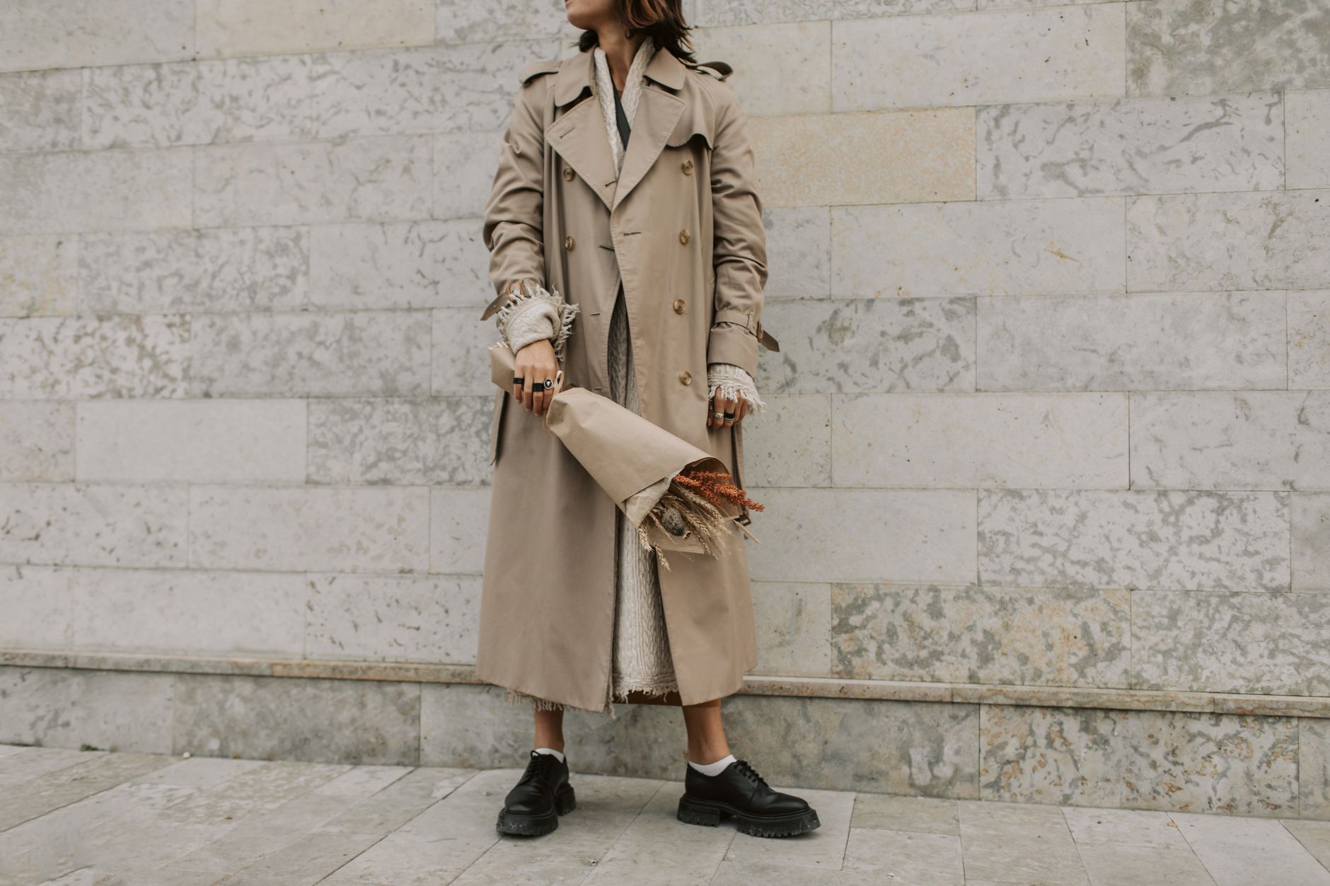 Close-up of lightweight layered knitwear in neutral tones styled casually