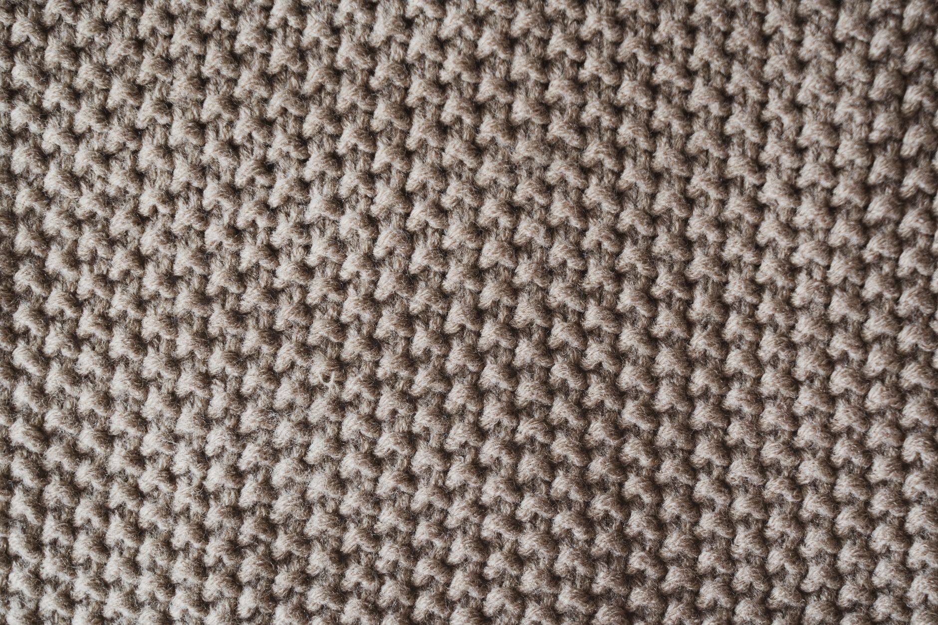 Close-up of ribbed knit fabric texture in a neutral earthy tone