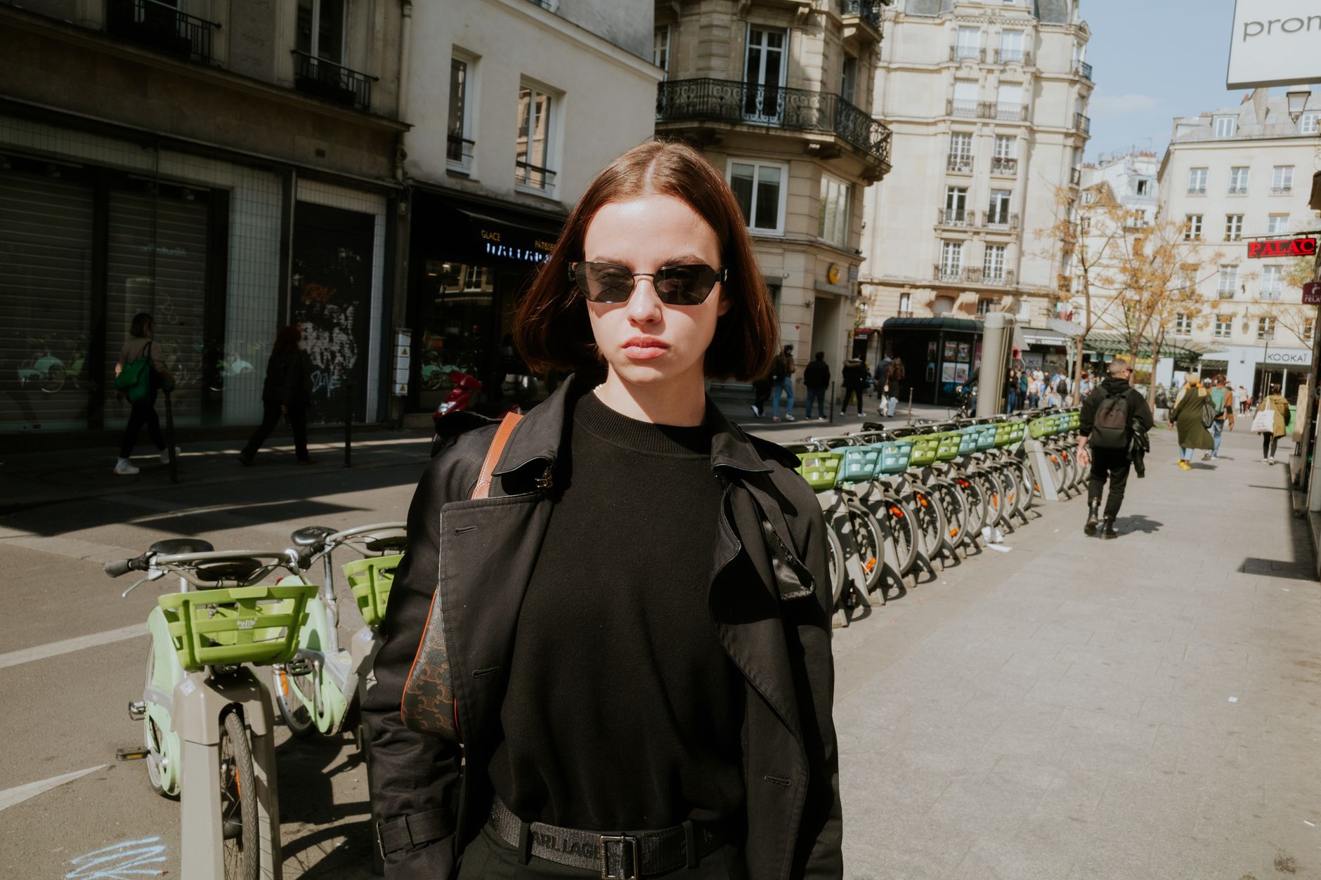 Stylish woman carrying a structured tote bag on a European city street